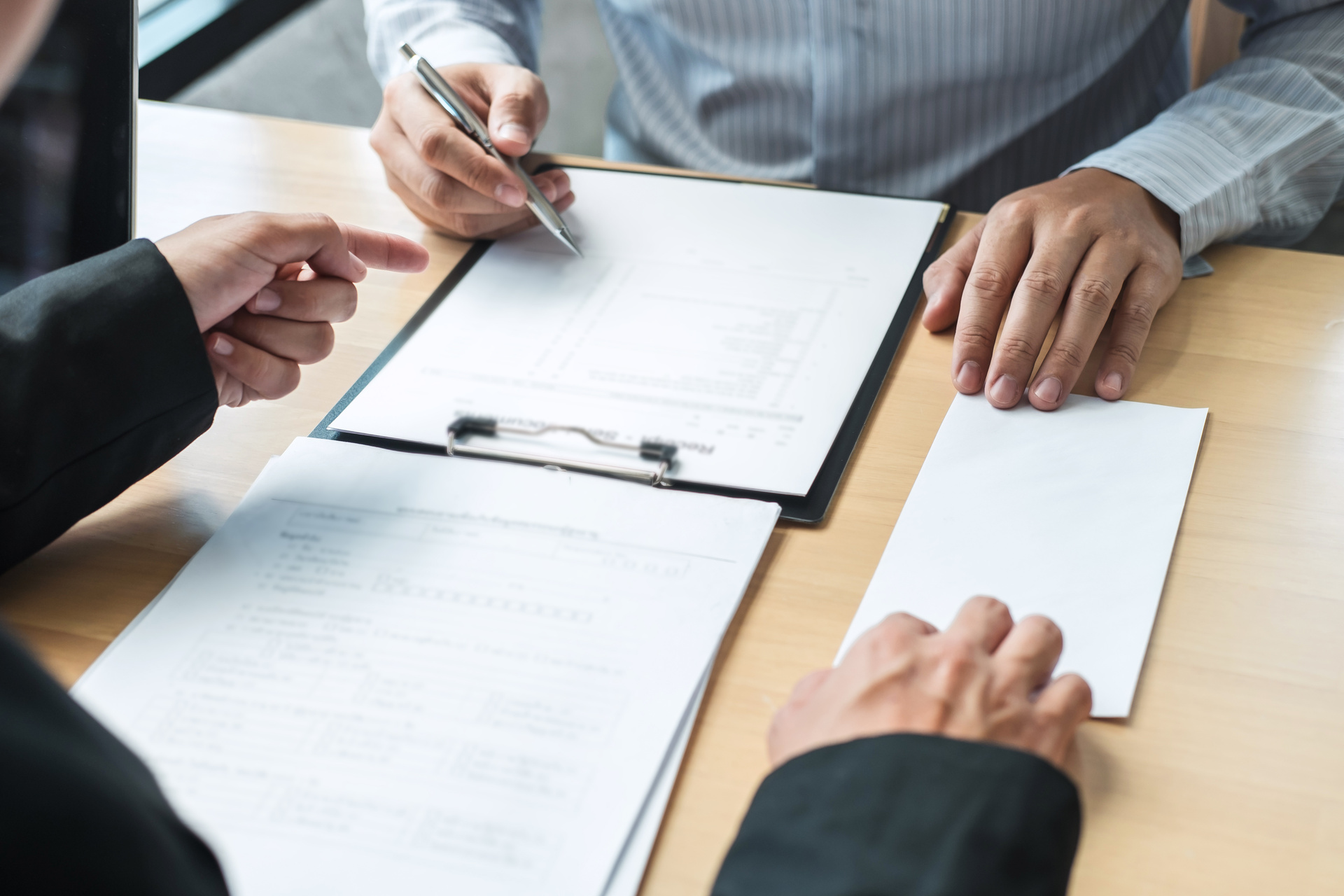 Someone pointing at a change order for a client to sign.