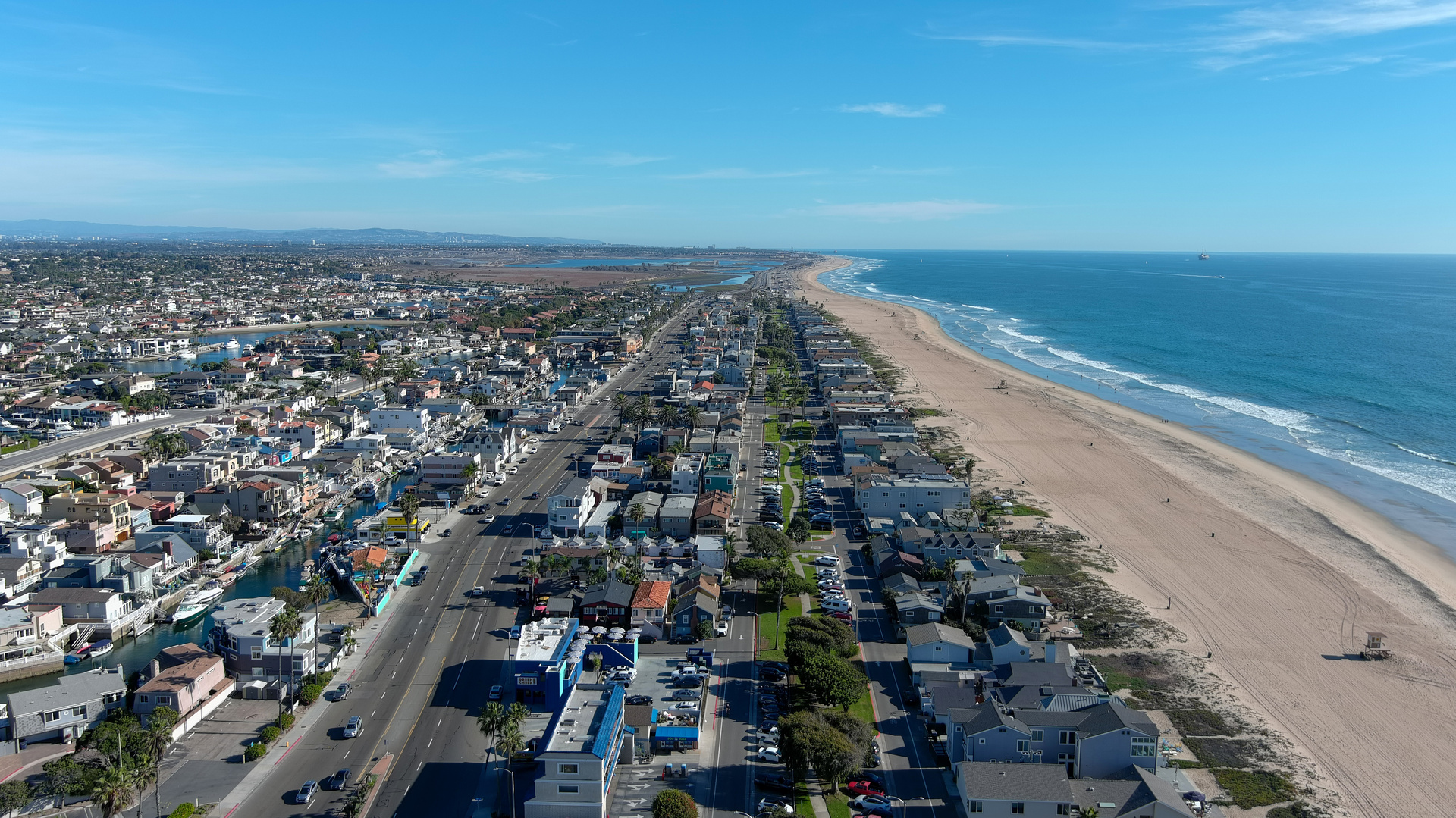 A picture of Huntington Beach in Orange County that shows the beach and residential homes.