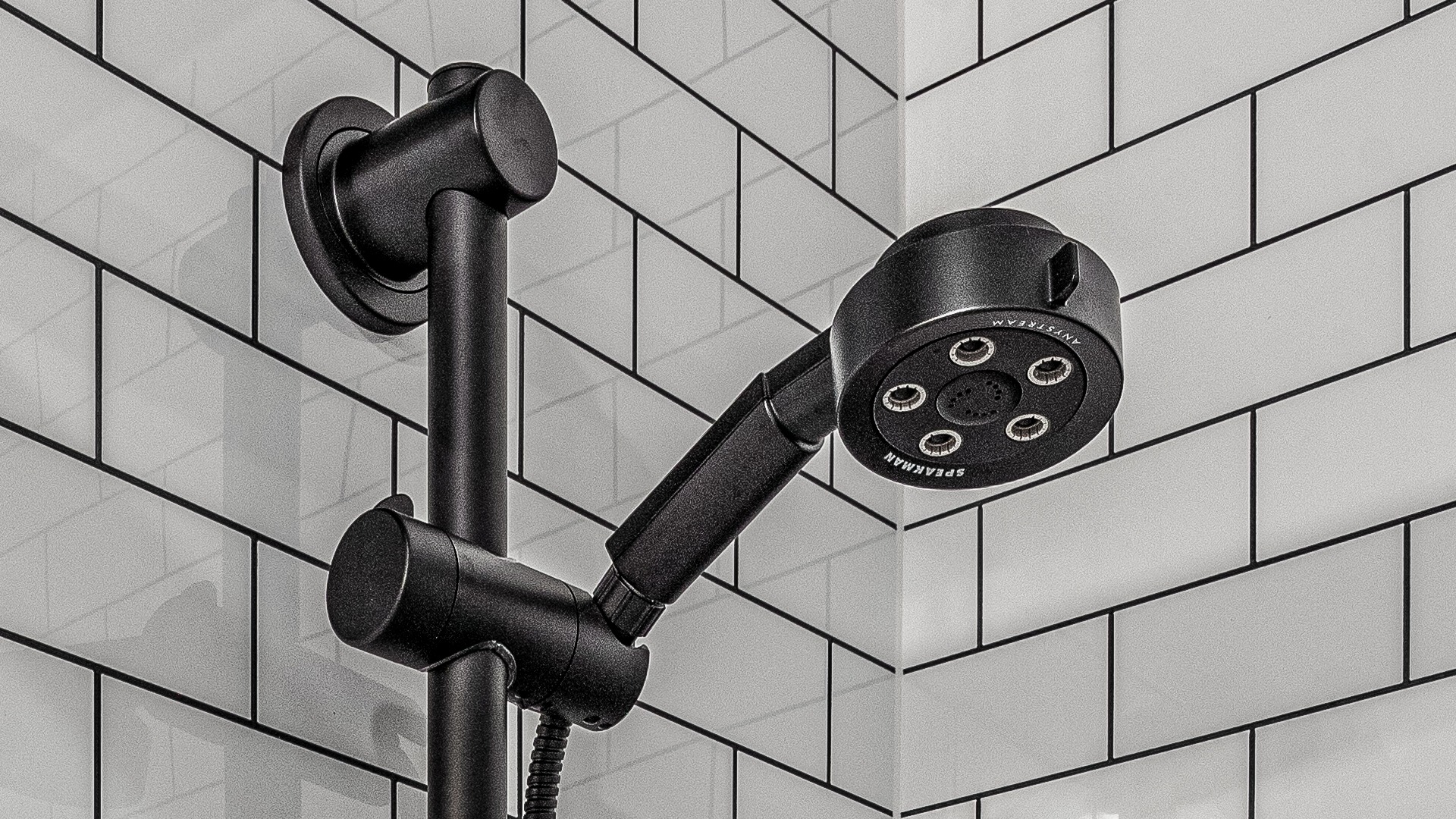 A matte black shower head in a new remodel
