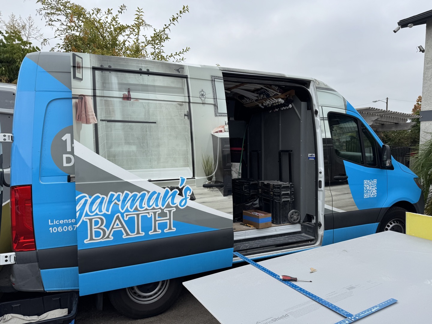 A Shugarman's Bath van with it's door open, carrying tools and supplies.