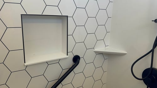 A newly installed shower with a hexagonal tile-shaped BP-Cor2 shower wall