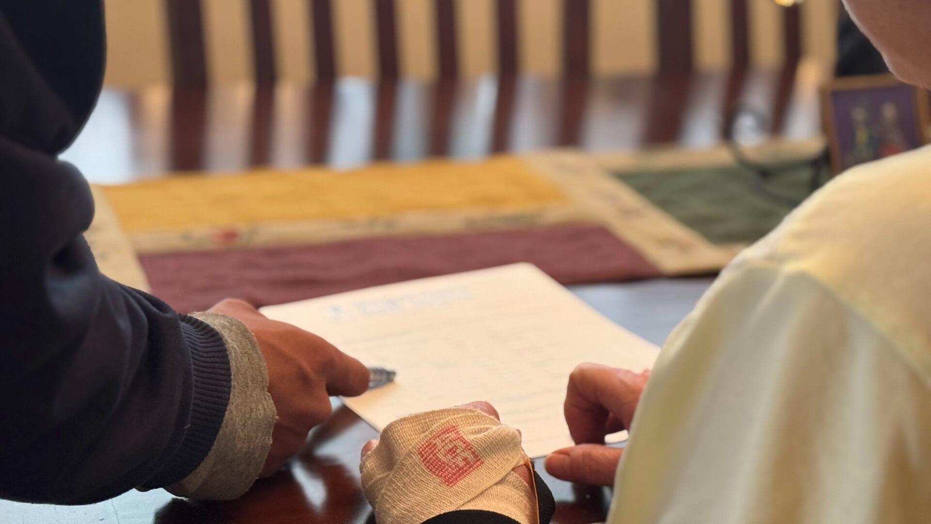 A woman and an installer assistant going over a shower remodeling contract