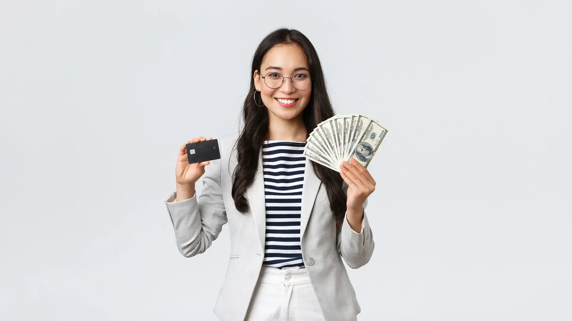 Woman holding a credit card and cash