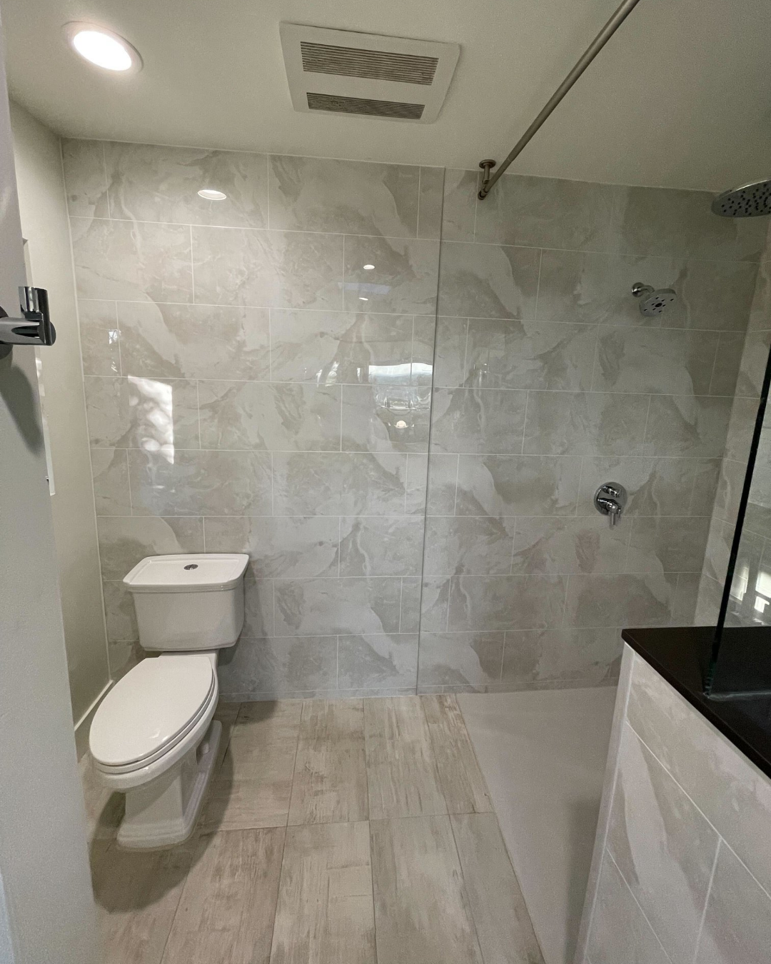 Inside a bathroom with a remodeled walk-in shower