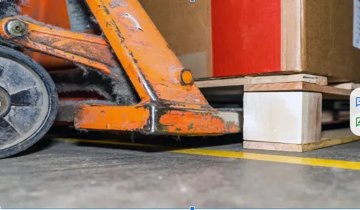 A forklift about to lift a pallet
