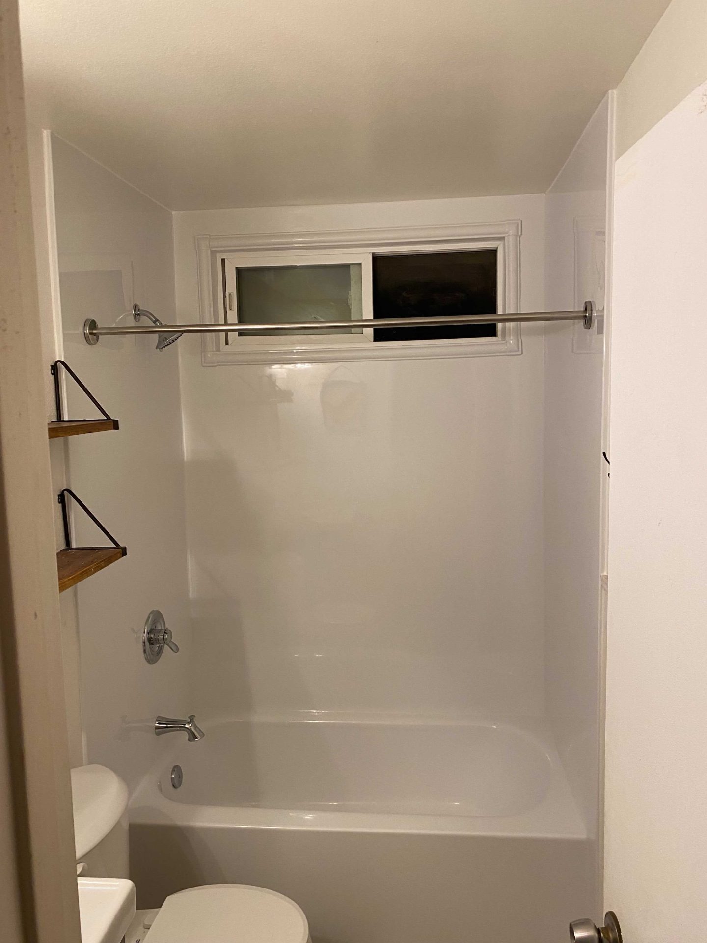 A remodeled traditional shower with a bathtub