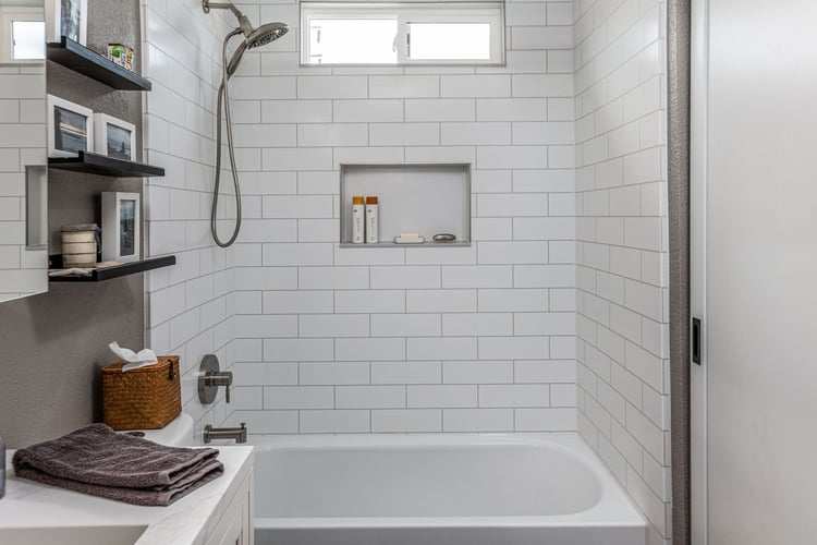 A remodeled shower with 4" x 12" grayline subway pattern