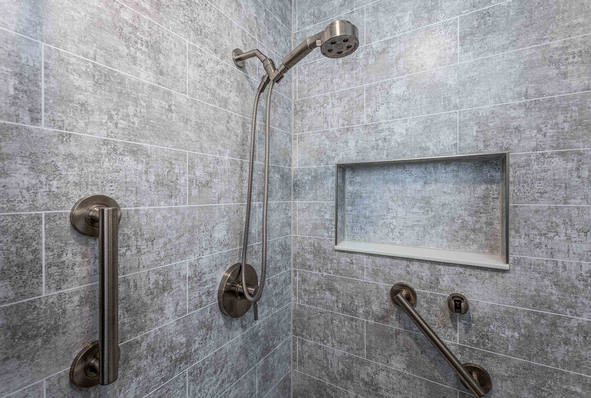 Metapeak Walls shower remodel with two grab bars and a shower niche