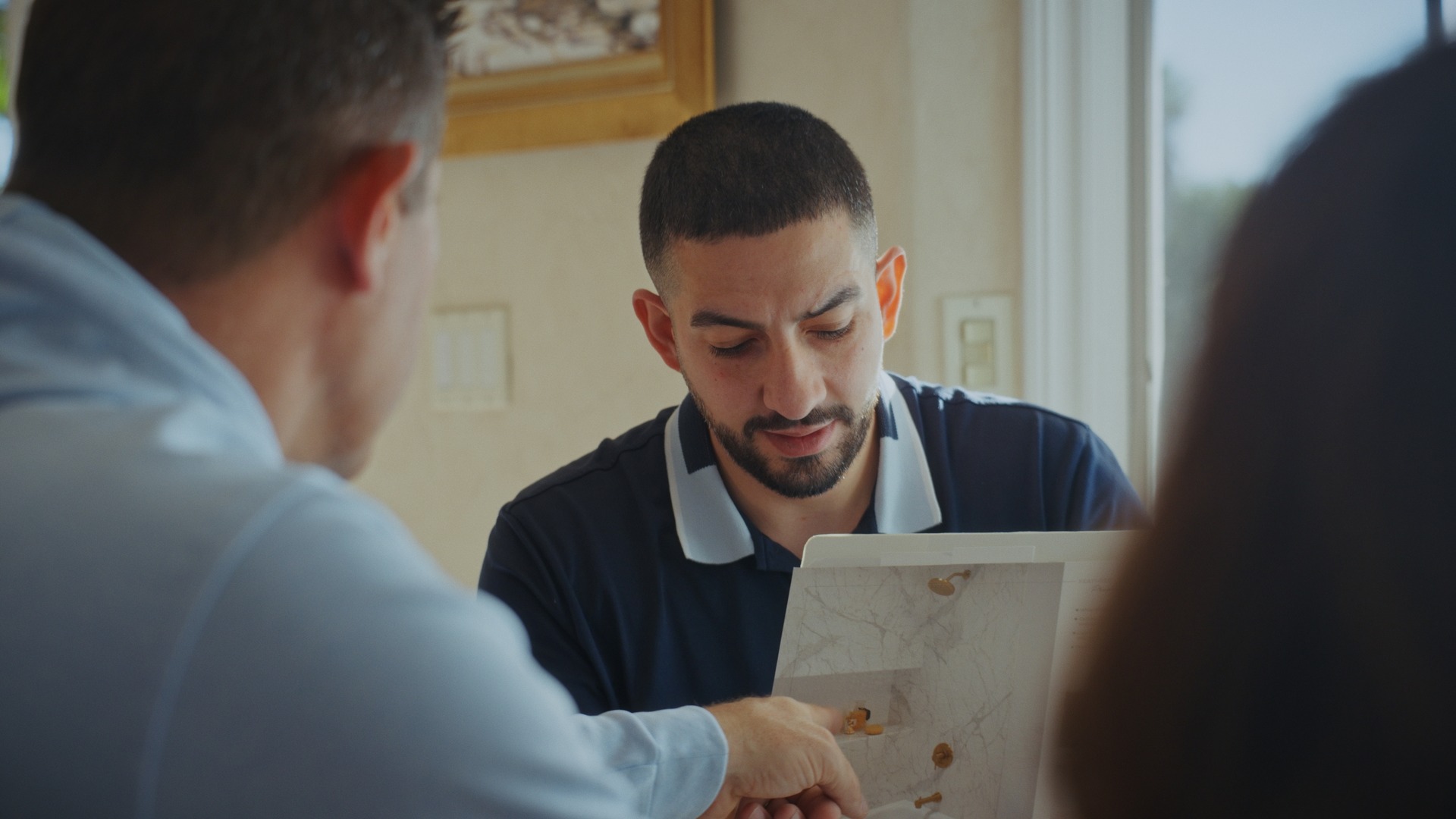 Wes, a Shugarman's Bath Design Consultant, showing homeowners shower design options