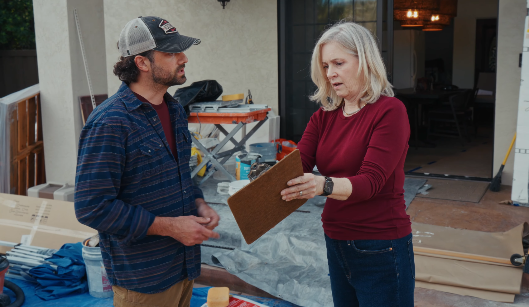 A contractor talking to a homeowner and disputing their quote