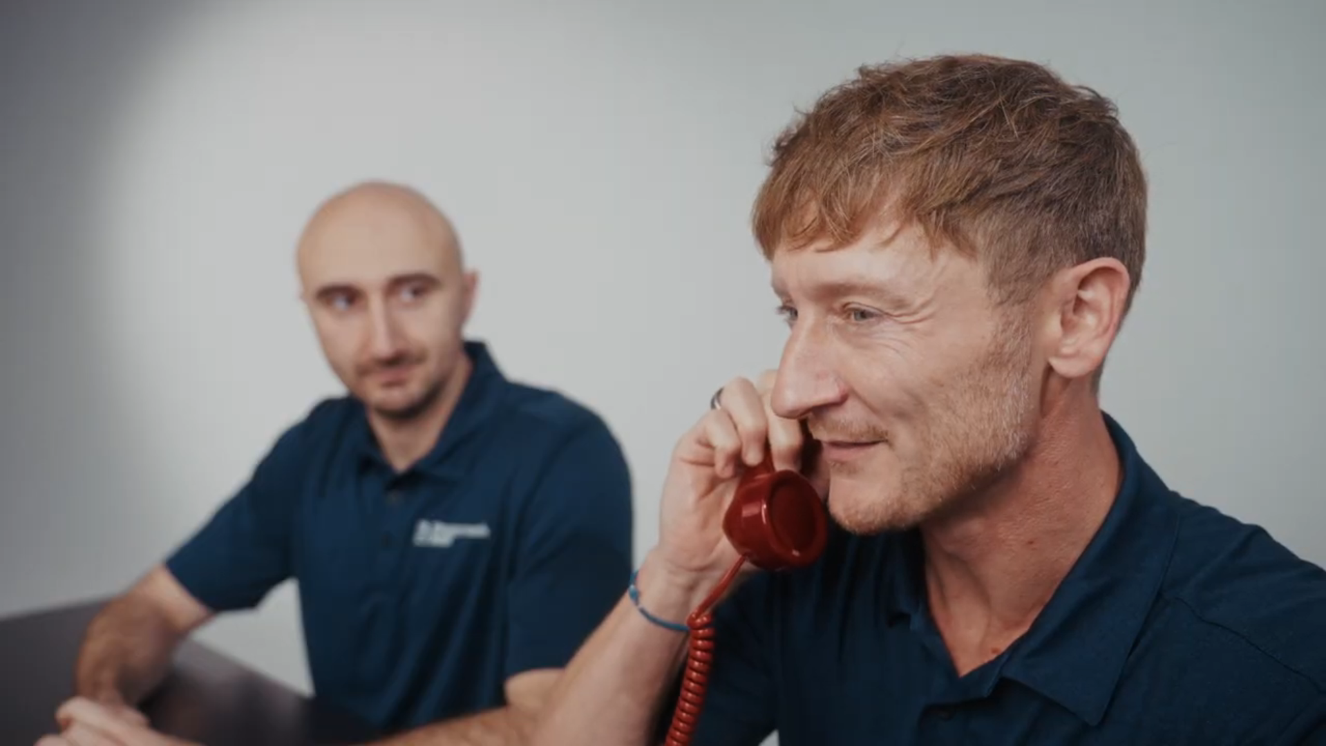 A scheduling Team member on the phone helping a customer with their shower remodel