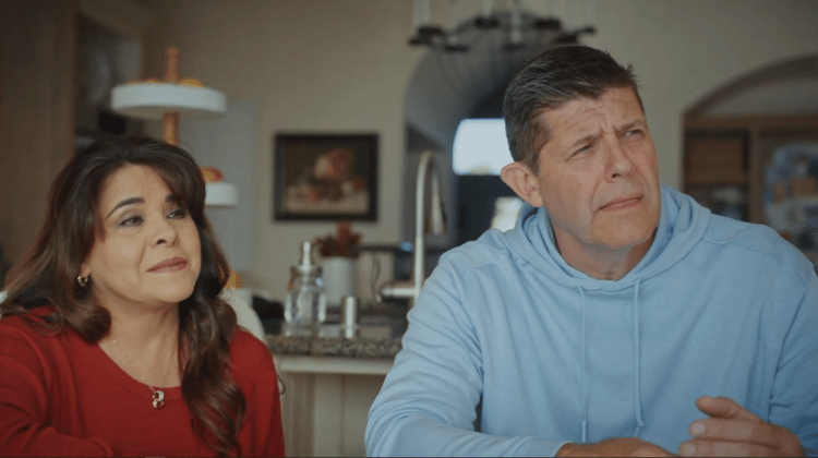 A married couple is listening and asking questions during a design consultation.