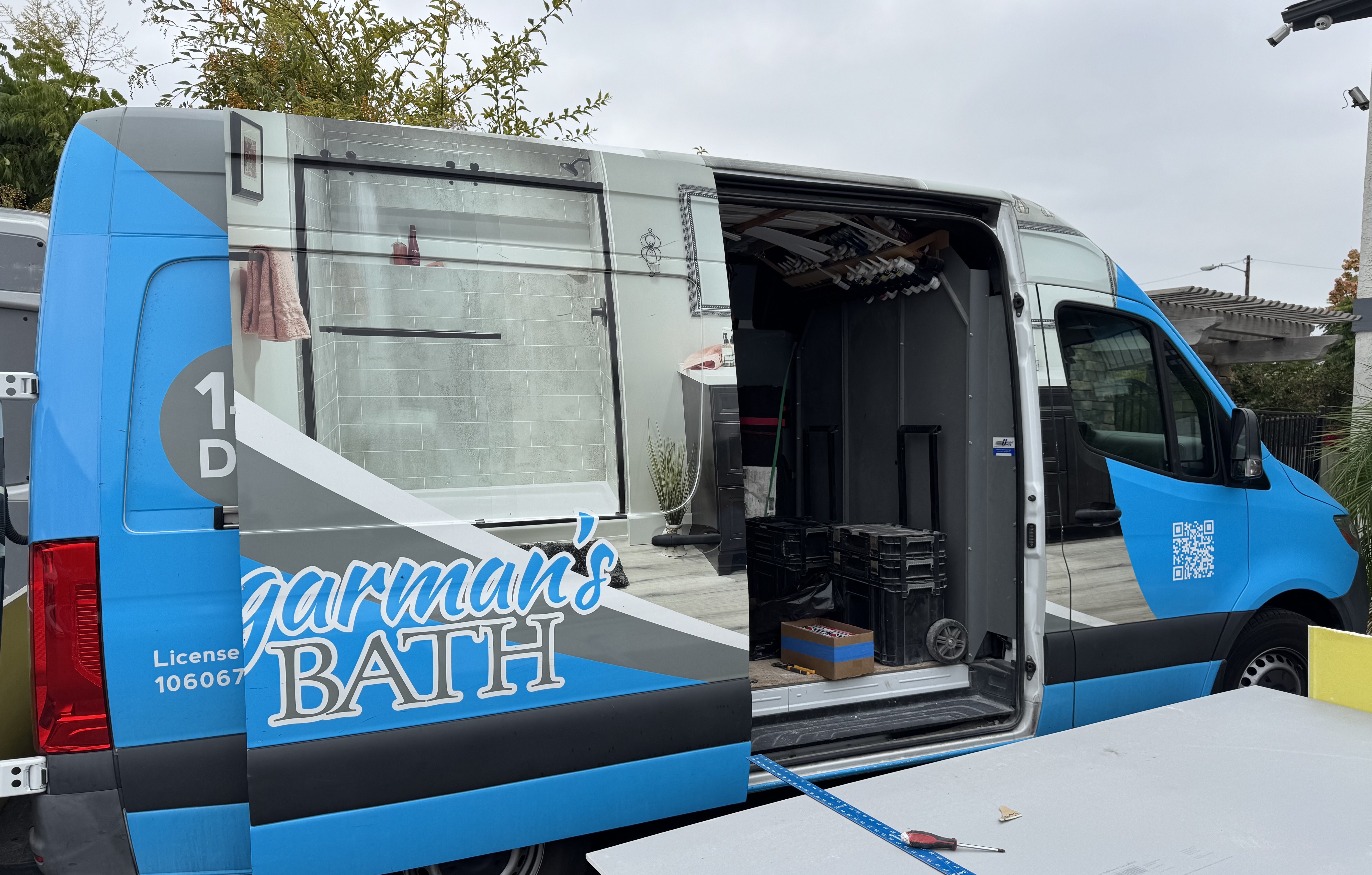 A Shugarman's Bath vehicle with its door open, showing tools and supplies