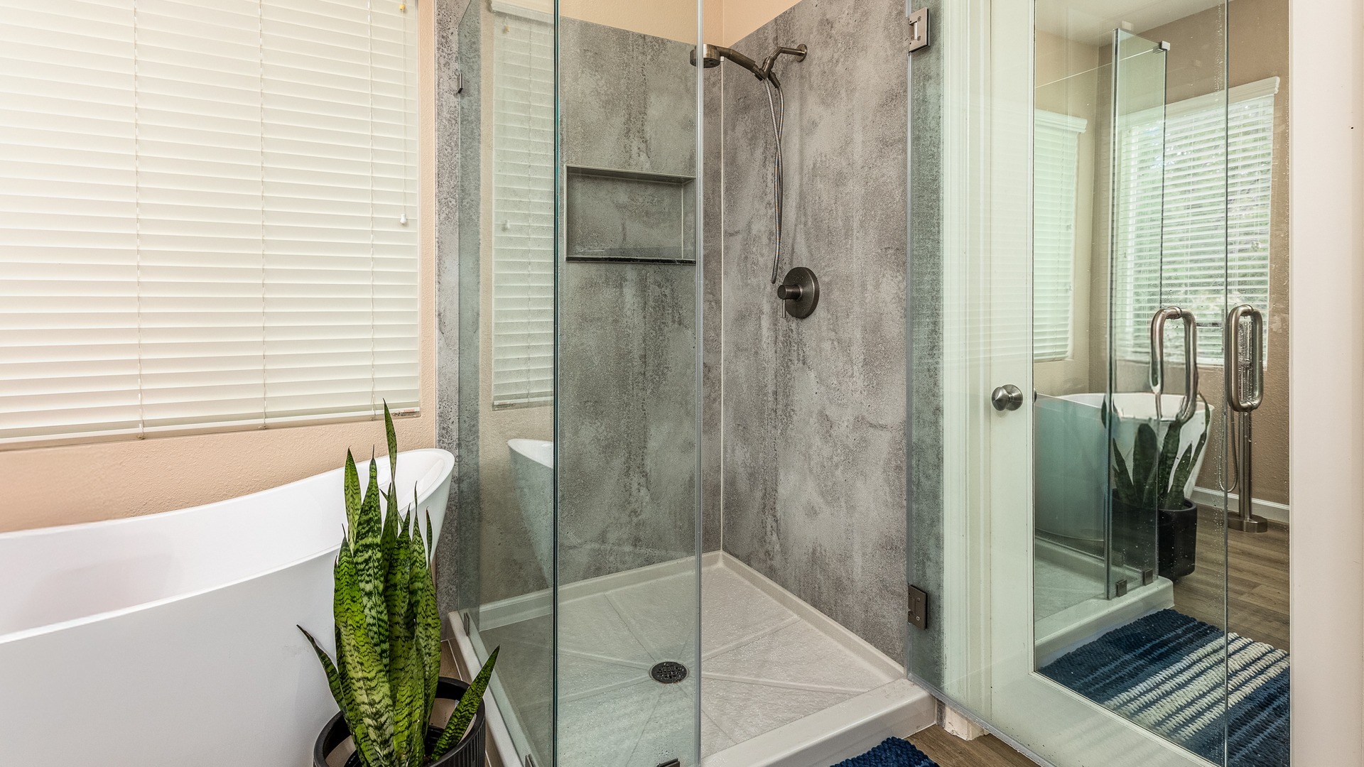 A Cali combo with a walk-in shower that has concrete walls