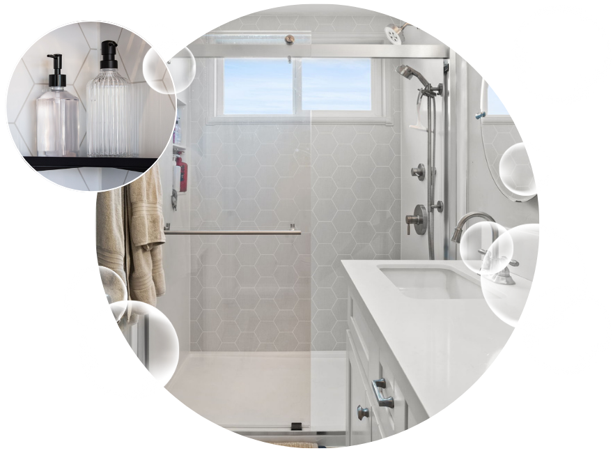 Walk-in shower with a window and glass door next to a white vanity