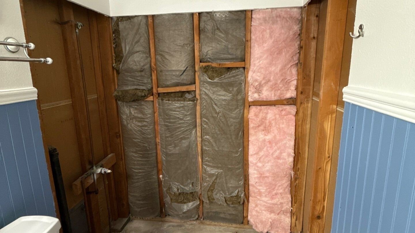 Inside a tub and shower area after demolition and ready for installation.