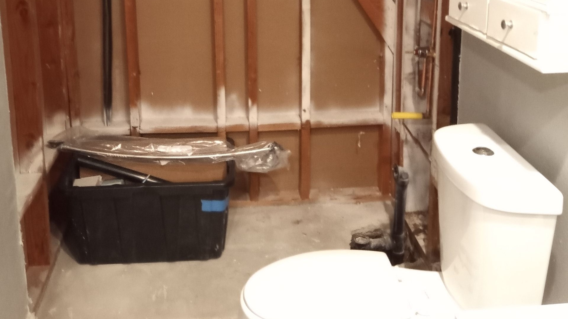A bathroom remodel project left abandoned with a demoed tub and shower area.