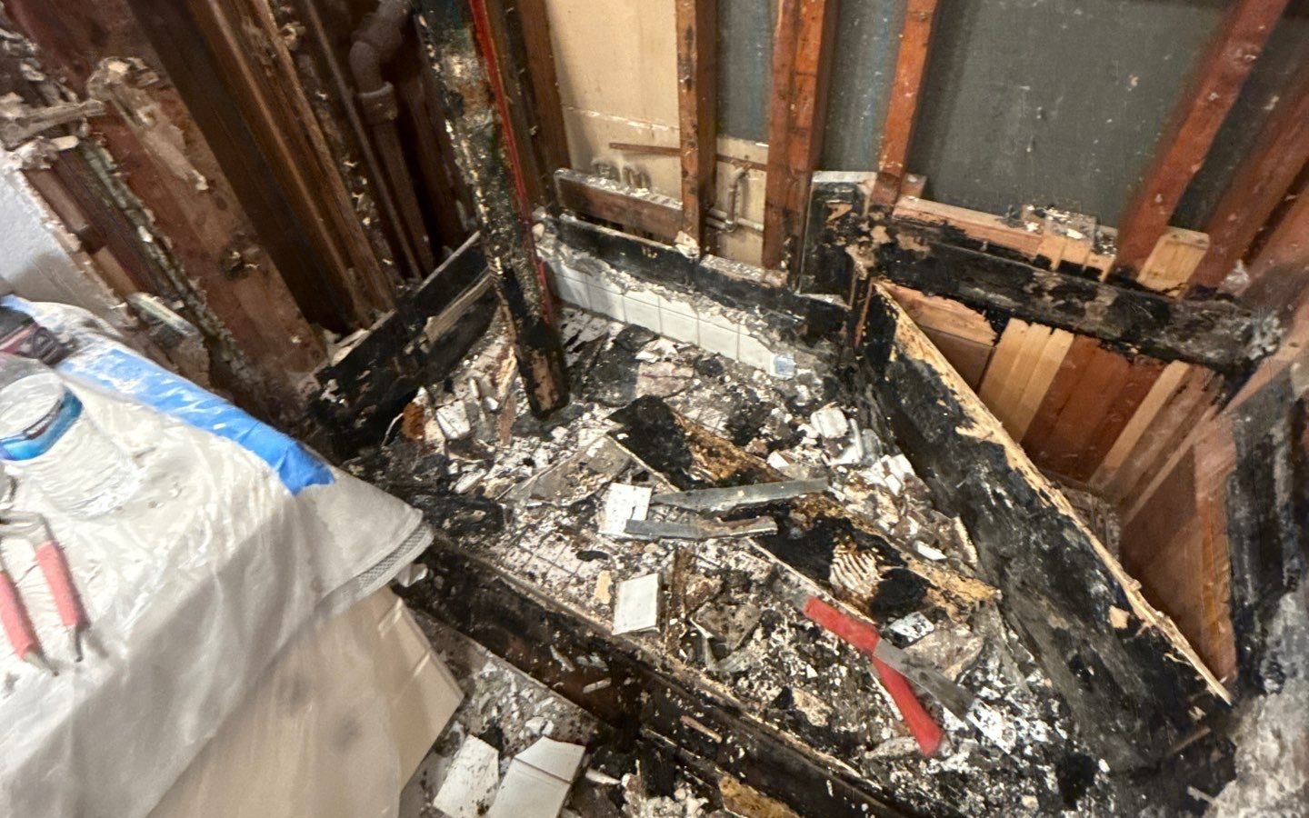 A demoed shower that was damaged by water, causing mold and wood rot.
