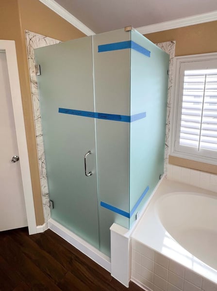 A shower enclosure with frosted glass