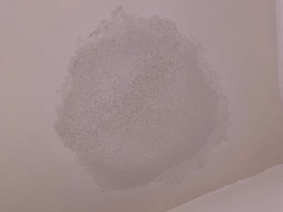 A wet spot on a ceiling by the shower