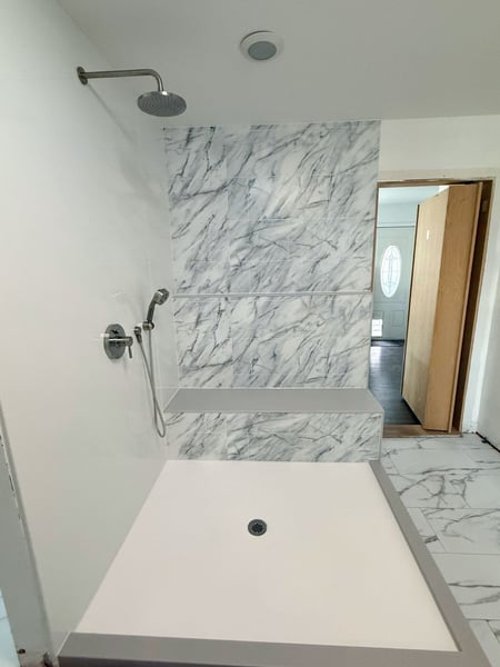 A remodeled walk-in shower with a custom seat