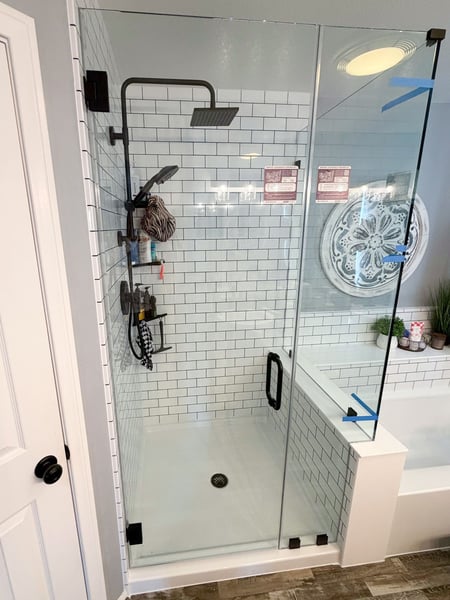 A Cali combo with subway tile shower walls and a glass enclosure for the walk-in shower