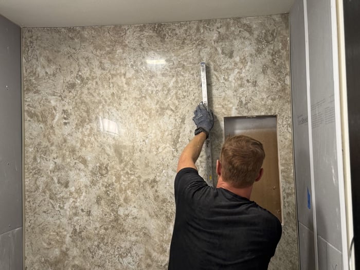 Professional installer applying the BP-Cor2 surface to the DensShield Backer Board