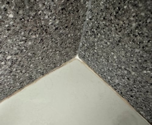 Aged and cracked silicone at a corner in a shower