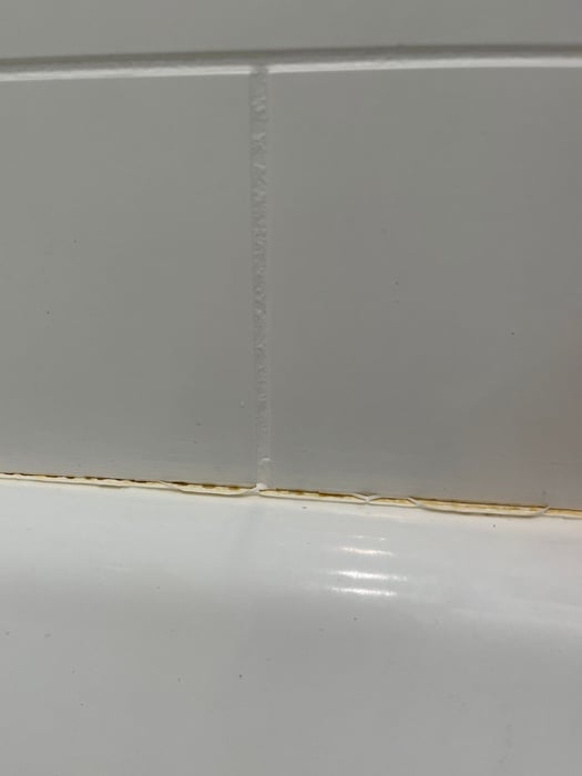 Silicone pulling away from a shower wall